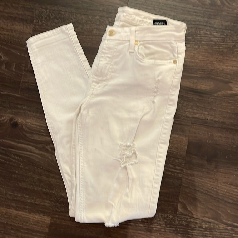 7 for all Mankind white ripped style, low-rise skinny jeans.